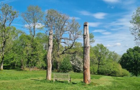 Totem poles and a bench